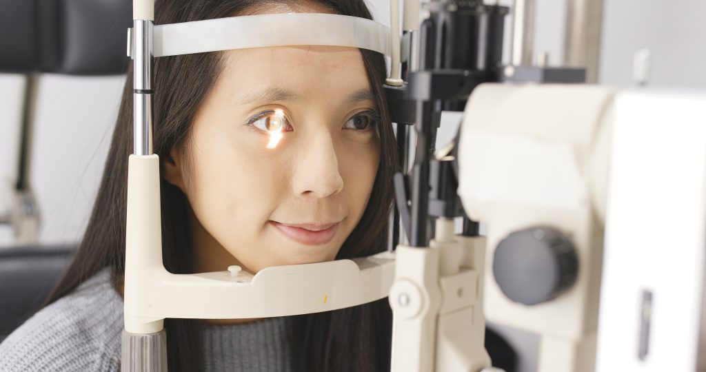 Woman doing eye test with optometrist in medical office